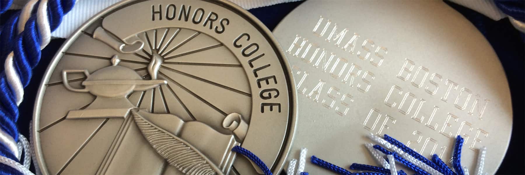 Silver medallions with Honors College inscribed on them.